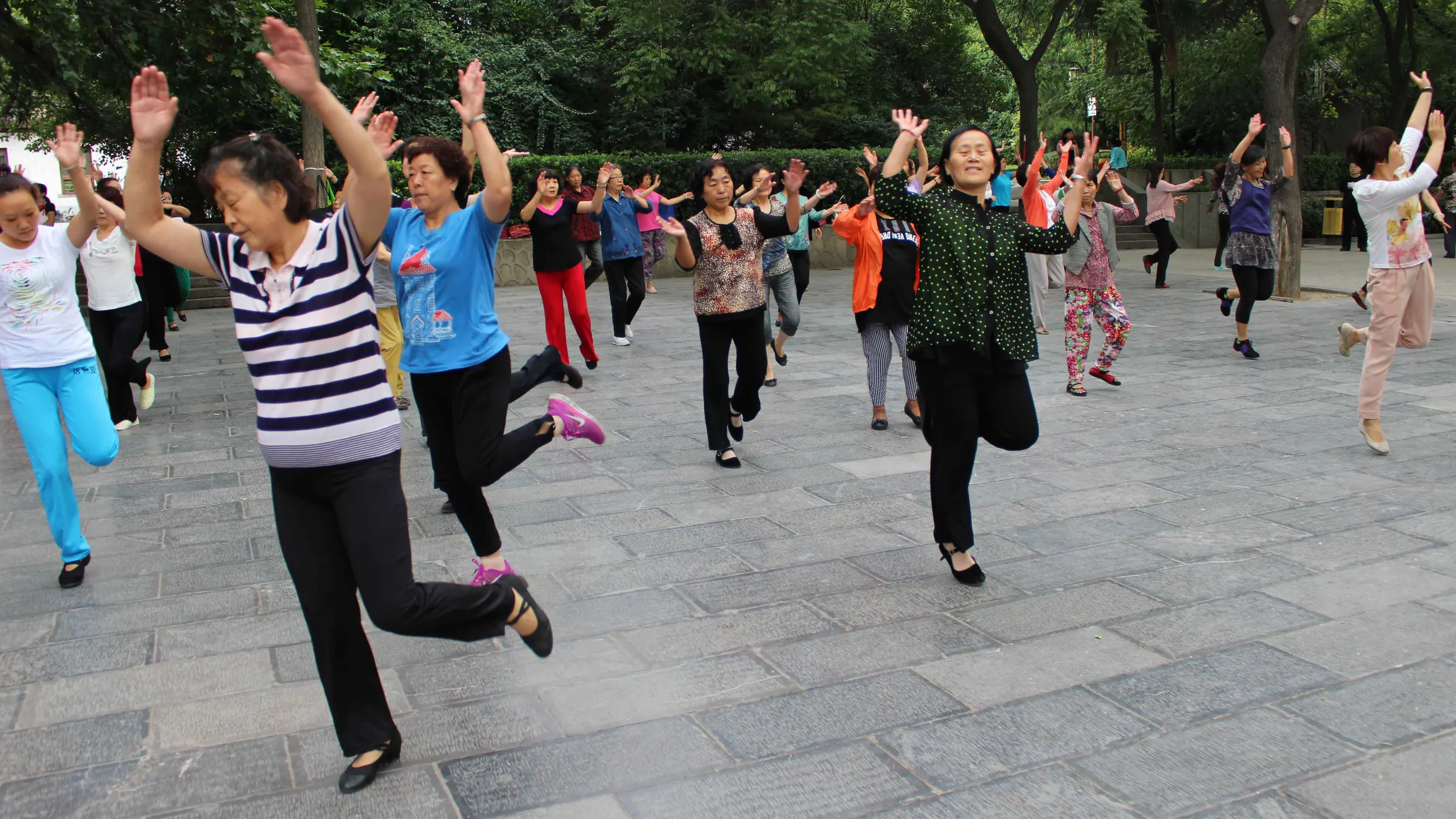 People dancing together in a park
